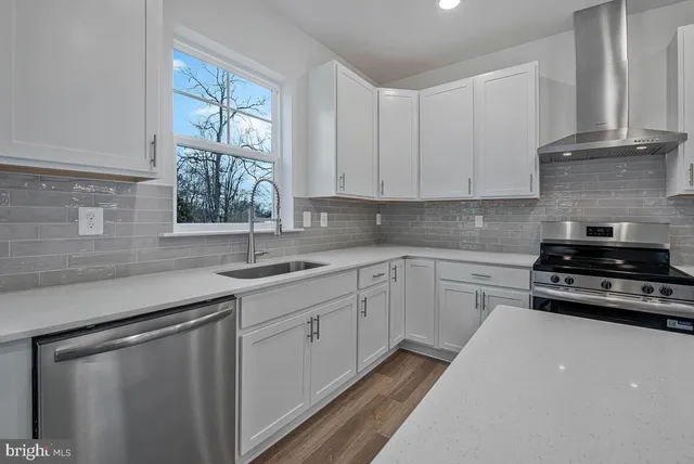 a kitchen with a sink and large window