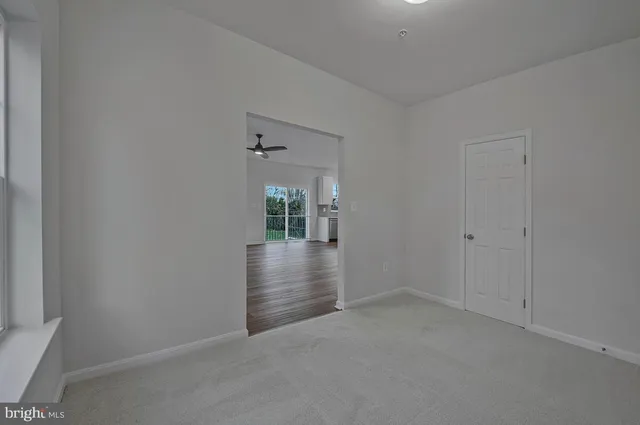 a view of livingroom with hardwood floor and kitchen view
