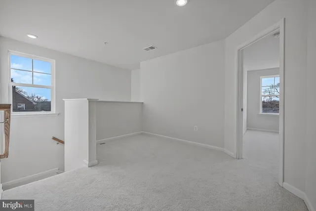 a bathroom with a sink a toilet and a window