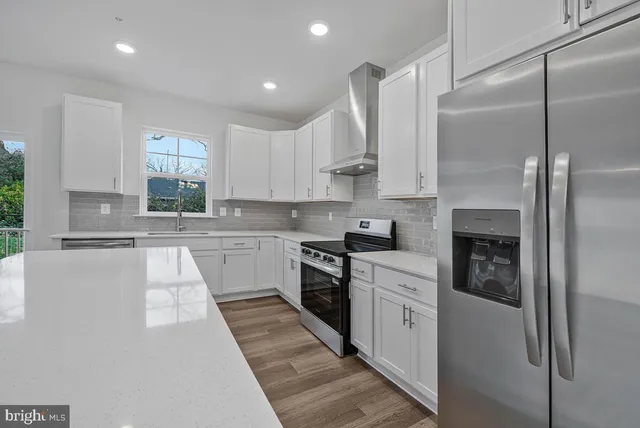 a view of kitchen with wooden floor and window