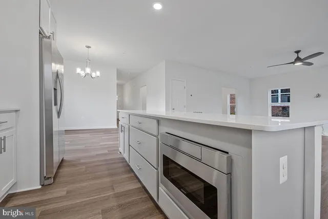 a kitchen with white cabinets and white appliances
