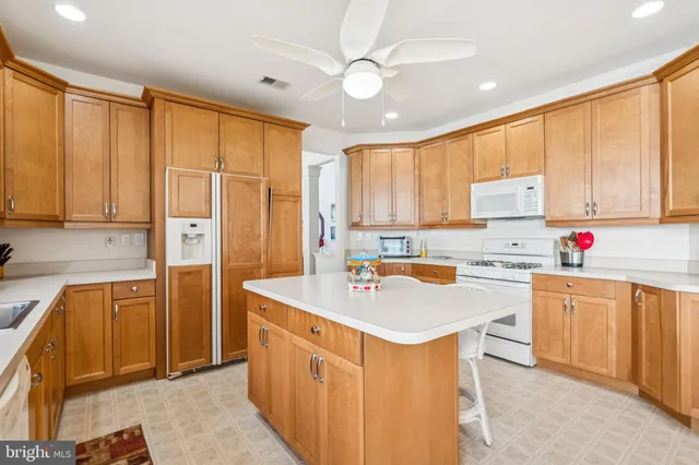 a kitchen with stainless steel appliances granite countertop a refrigerator sink and cabinets
