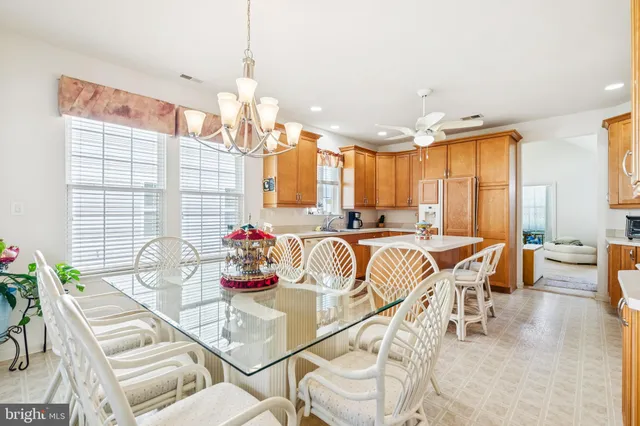 a view of a dining room with furniture and a chandelier