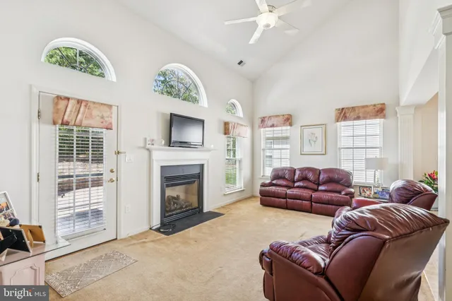 a living room with furniture fireplace and a window