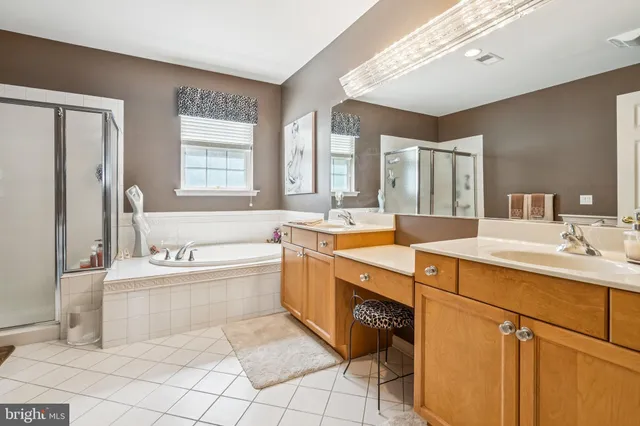 a bathroom with a tub sink and mirror