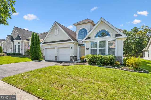 a view of house with yard and outdoor seating