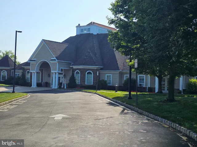 a front view of a house with yard and green space