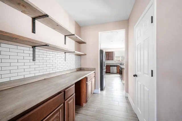a kitchen with a sink stove and cabinets