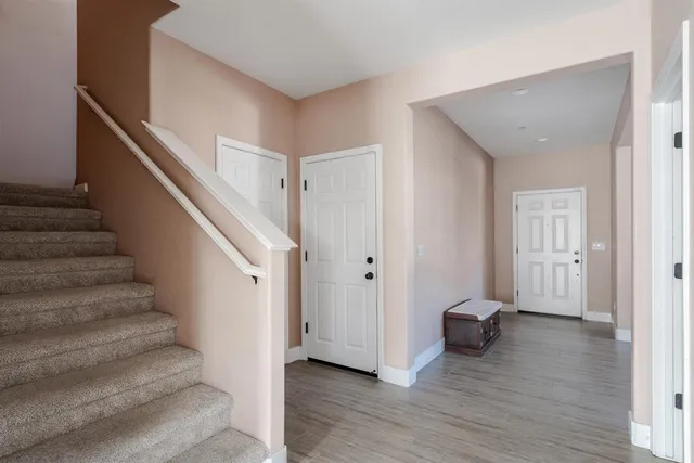 a view of entryway with wooden floor and stairs