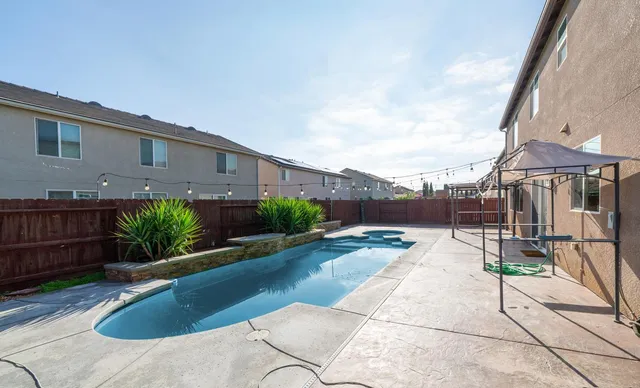 a view of a house with backyard and sitting area
