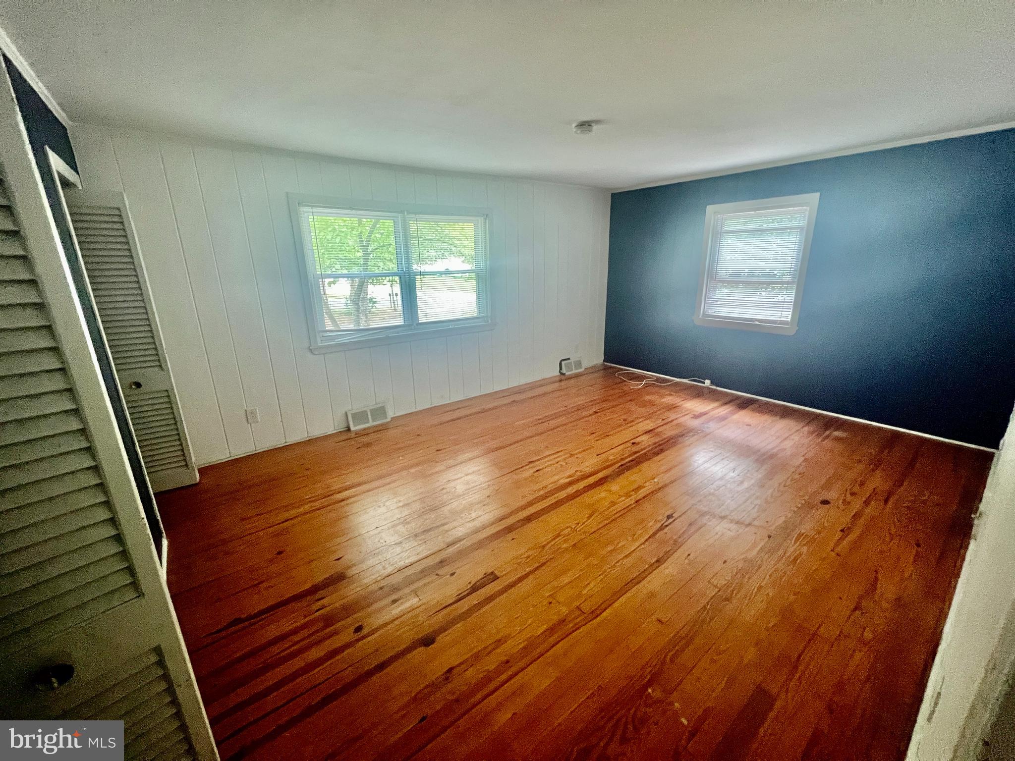 401 Bethel Mill Road, Unit A Pitman, NJ 08071 - Photo 14 of 18 a view of an empty room with wooden floor and a window