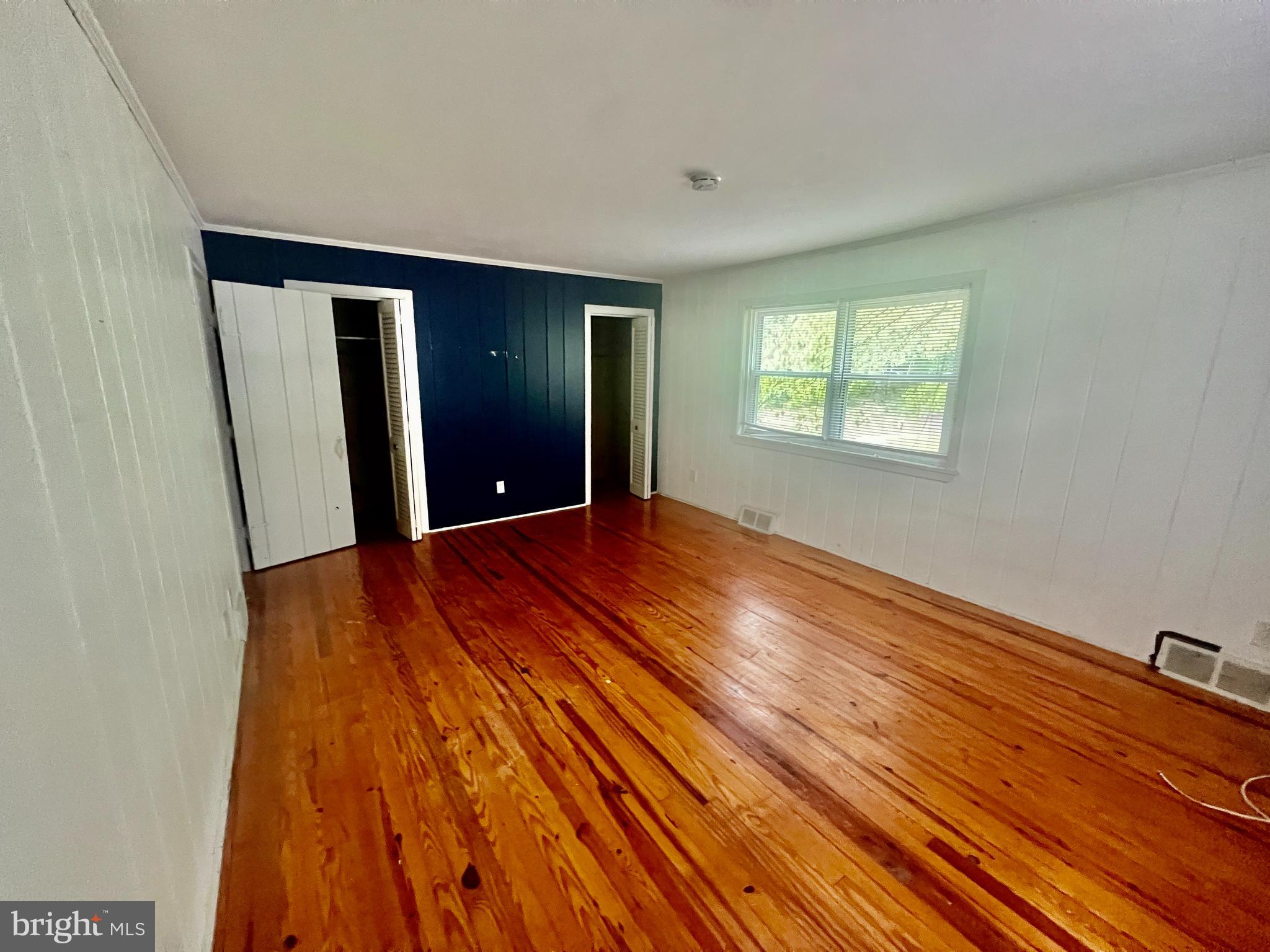 401 Bethel Mill Road, Unit A Pitman, NJ 08071 - Photo 15 of 18 a view of an empty room with wooden floor and a window