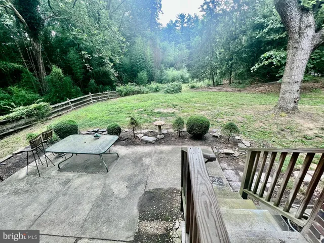 a view of a backyard with sitting area