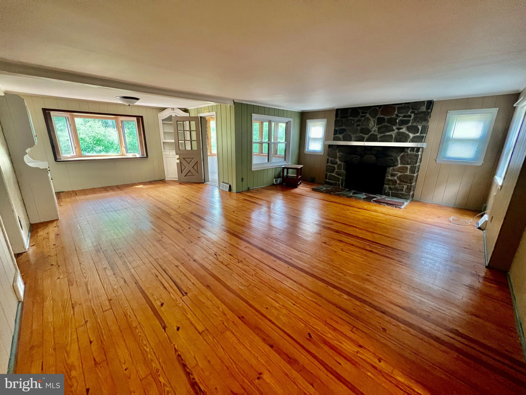 401 Bethel Mill Road, Unit A Pitman, NJ 08071 - Photo 4 of 18 a view of empty room with wooden floor and fireplace