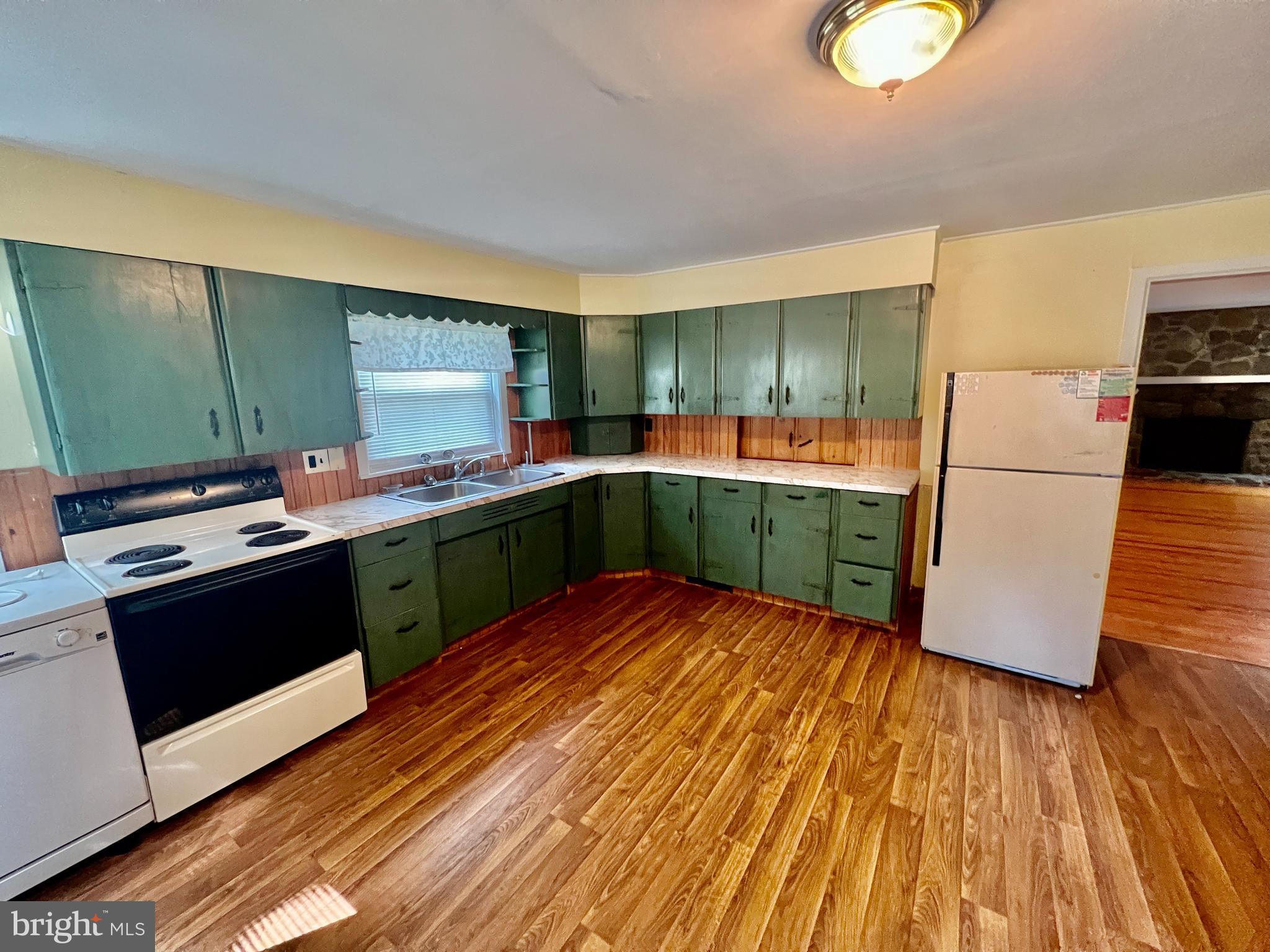 401 Bethel Mill Road, Unit A Pitman, NJ 08071 - Photo 8 of 18 a kitchen with stainless steel appliances granite countertop a sink a stove top oven and wooden floors