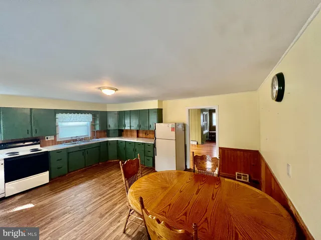 a kitchen with a table and chairs in it