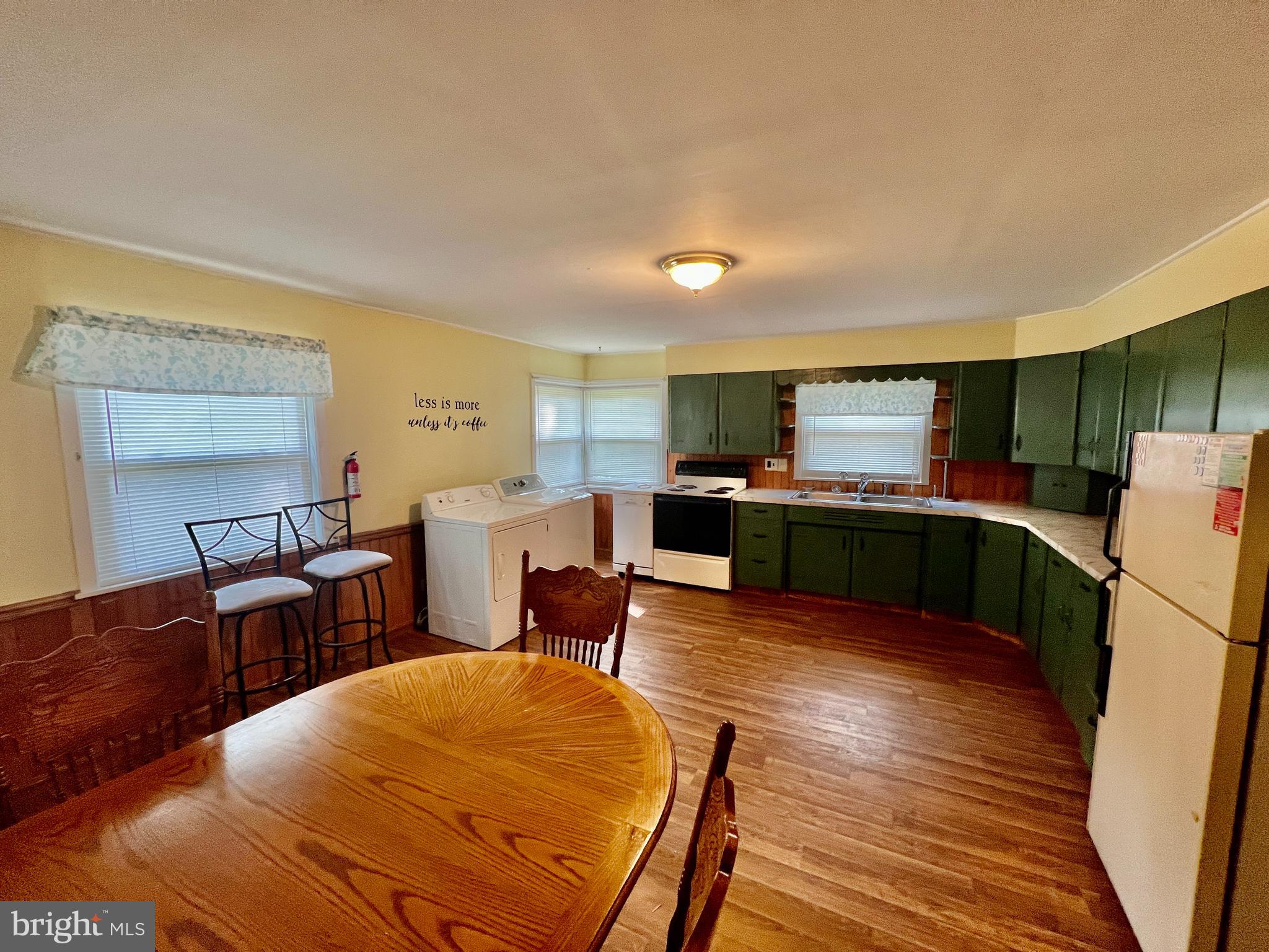401 Bethel Mill Road, Unit A Pitman, NJ 08071 - Photo 10 of 18 a kitchen with sink a refrigerator and chairs