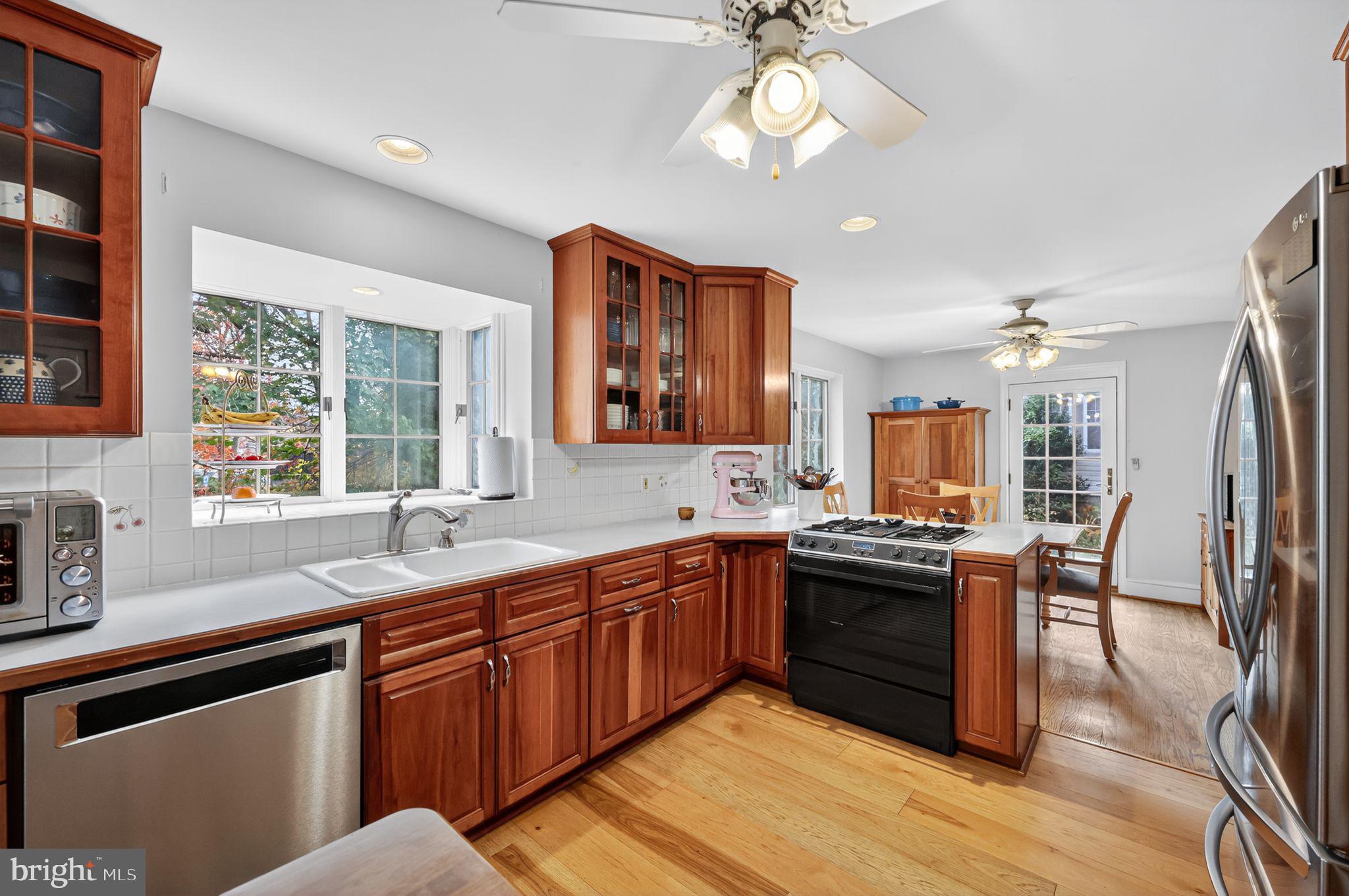 240 Hopkins Avenue Haddonfield, NJ 08033 - Photo 12 of 36 a kitchen with stainless steel appliances granite countertop a sink and wooden cabinets
