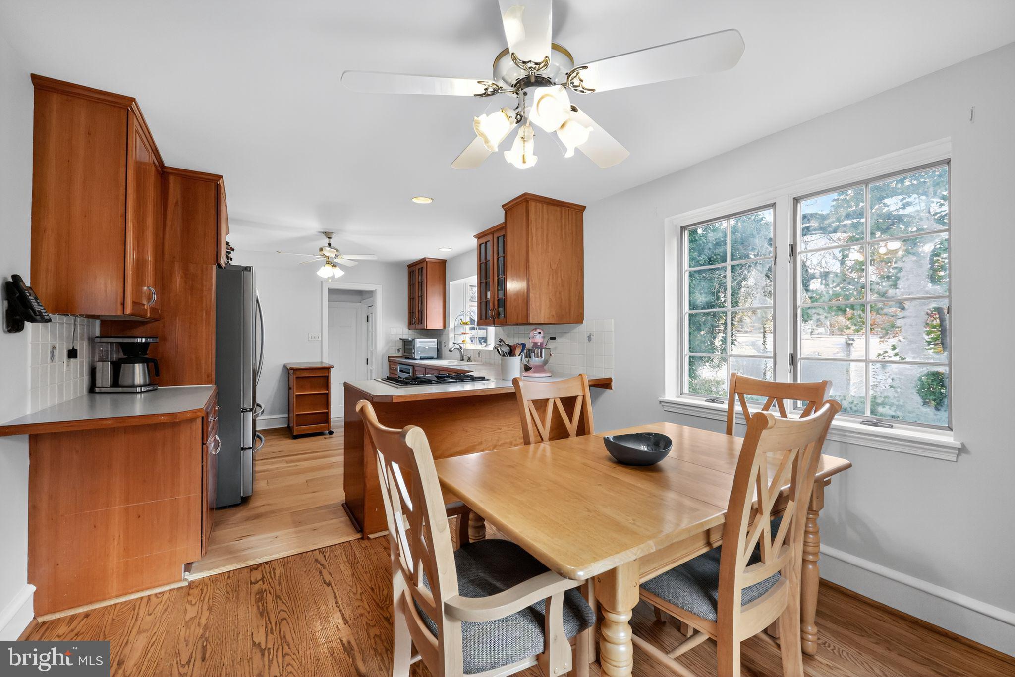 240 Hopkins Avenue Haddonfield, NJ 08033 - Photo 14 of 36 a dining room with furniture a window potted plants and kitchen view
