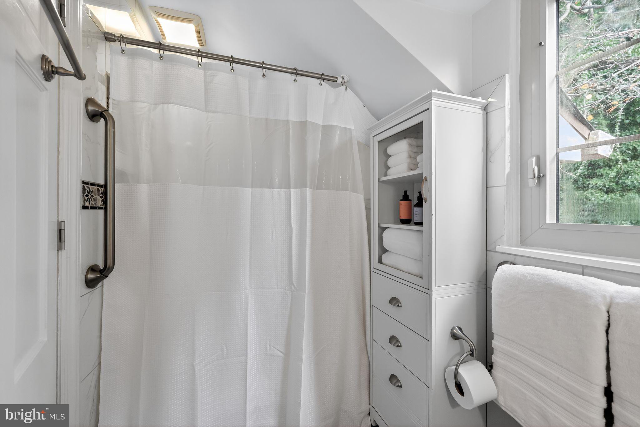 240 Hopkins Avenue Haddonfield, NJ 08033 - Photo 22 of 36 a bathroom with a shower and a mirror