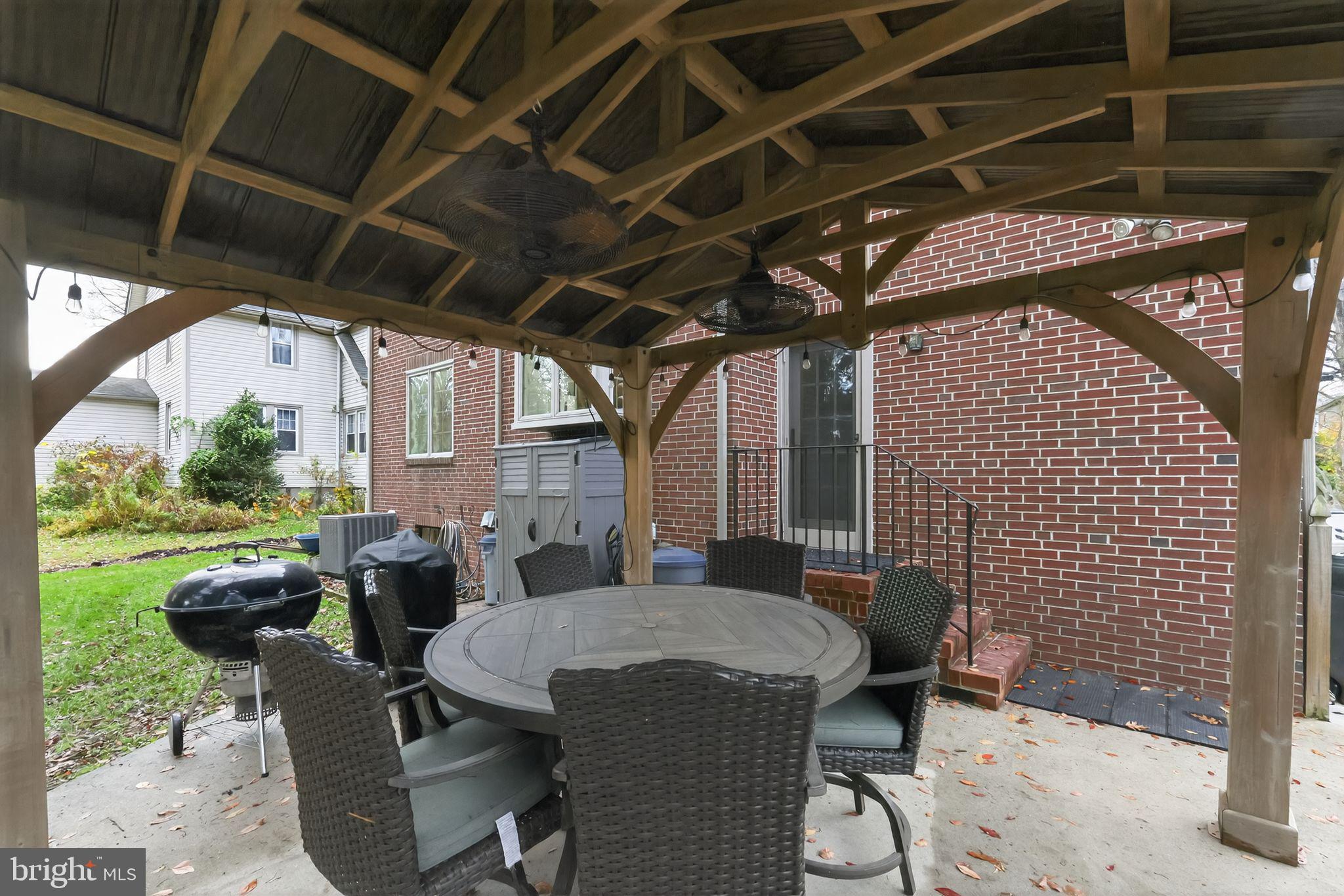 240 Hopkins Avenue Haddonfield, NJ 08033 - Photo 32 of 36 a patio with table and chairs and potted plants