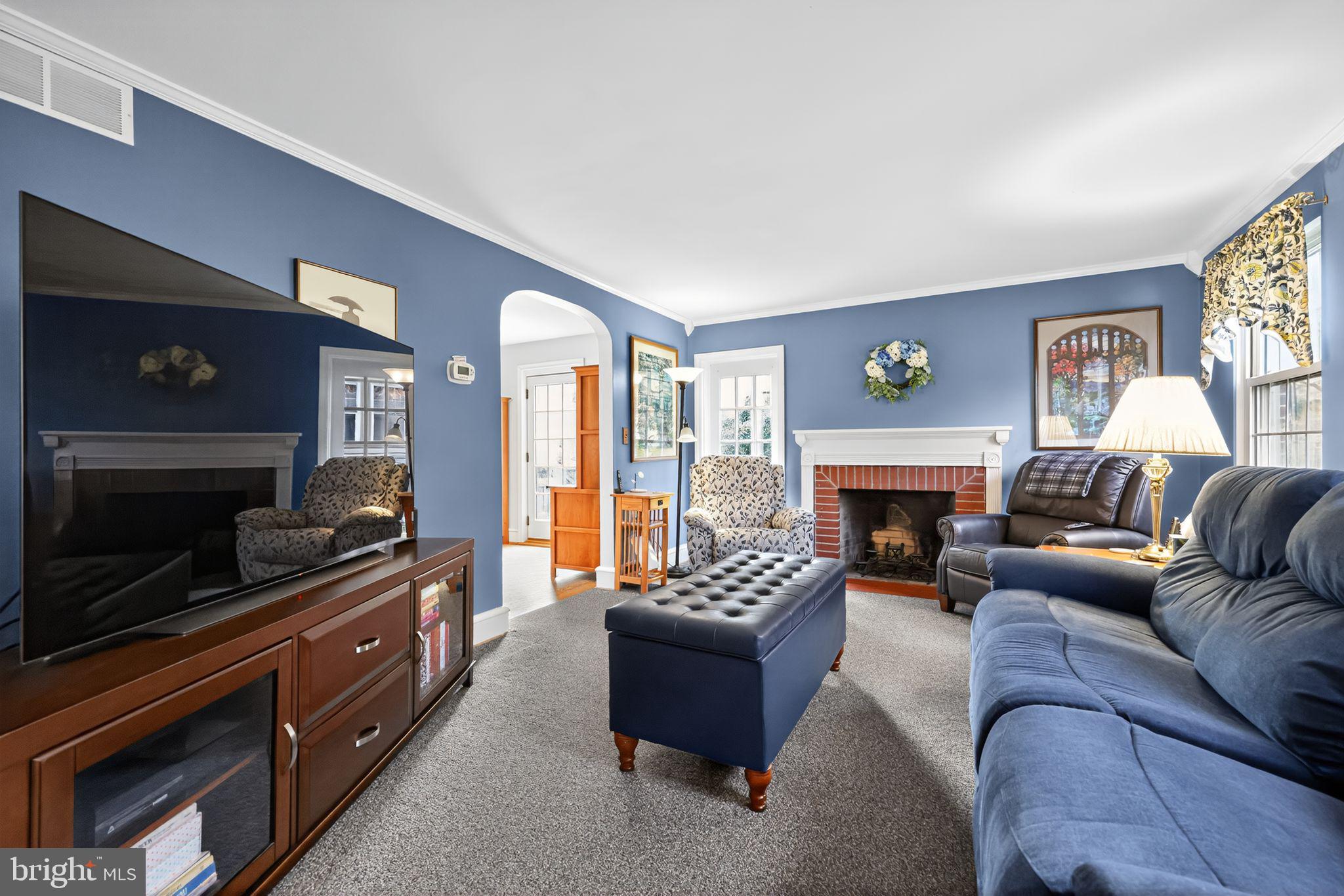 240 Hopkins Avenue Haddonfield, NJ 08033 - Photo 4 of 36 a living room with furniture a flat screen tv and a fireplace