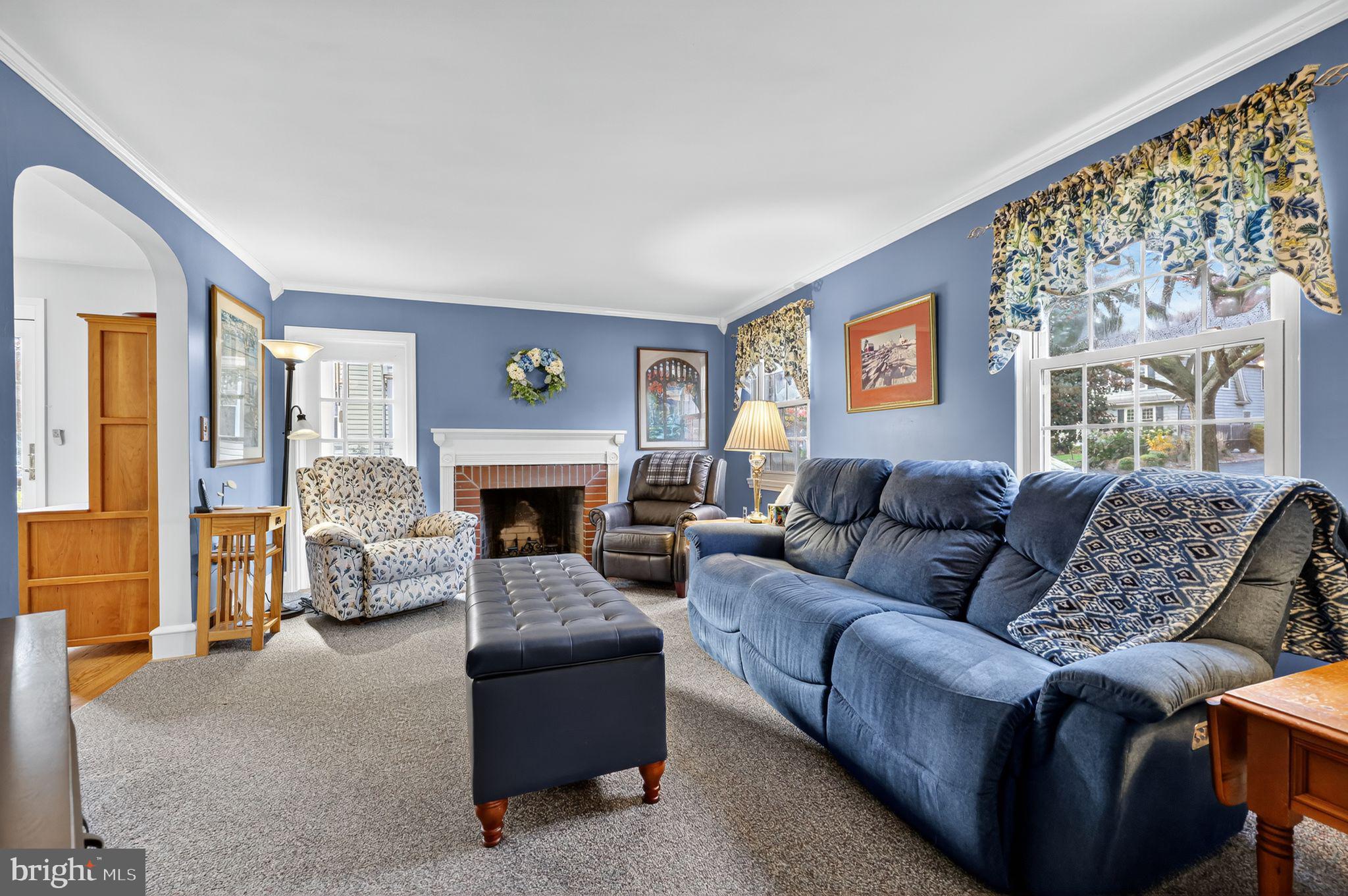 240 Hopkins Avenue Haddonfield, NJ 08033 - Photo 7 of 36 a living room with furniture a large window and a fireplace
