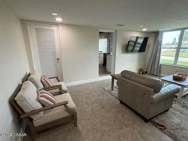 a living room with furniture rug and window