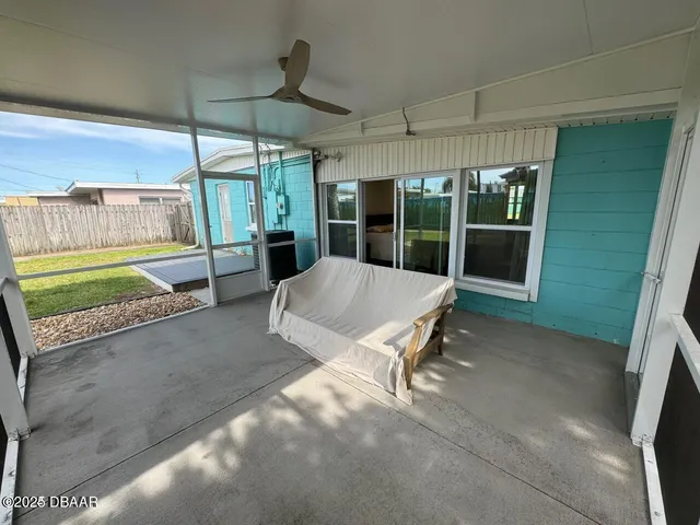 a view of a patio with a table and chairs