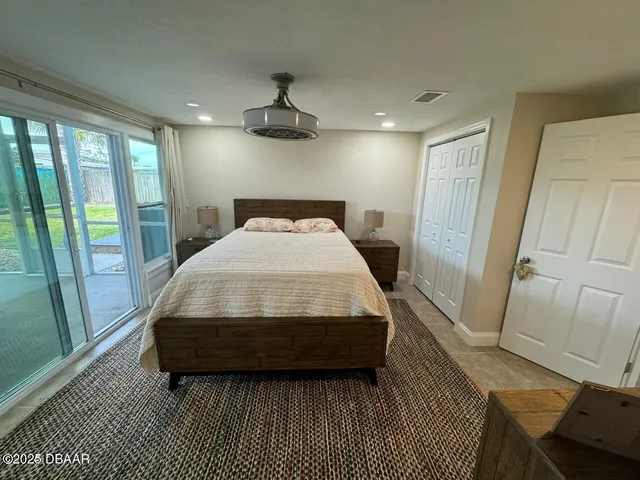 a bedroom with a bed a window with the rug