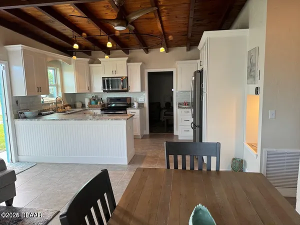 a kitchen with a table chairs and a refrigerator