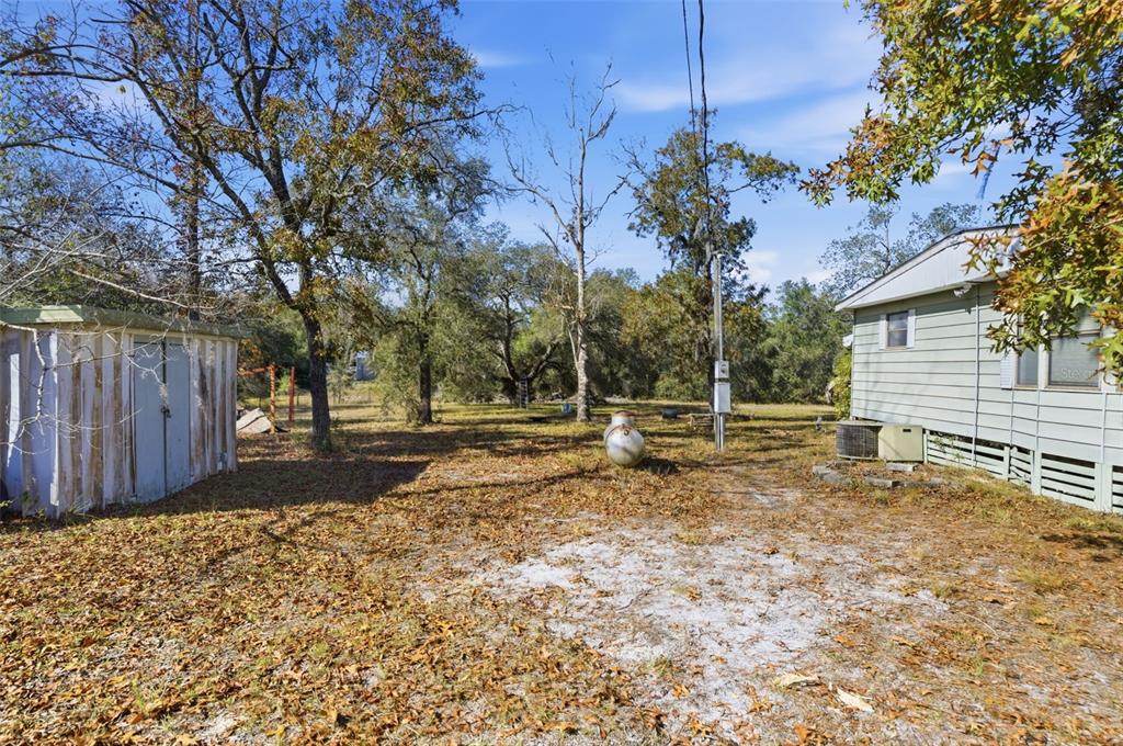 8045 Indian Trail Road Weeki Wachee, FL 34613 - Photo 38 of 49 a view of a yard with wooden fence