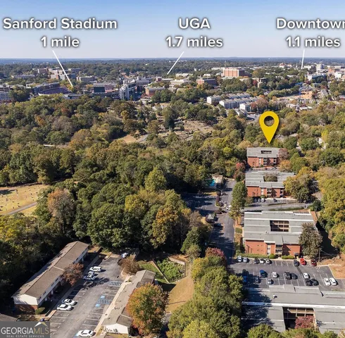 a view of a sign board with large trees