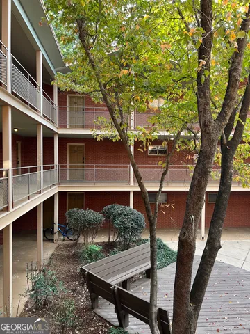 a view of a balcony with wooden floor and fence