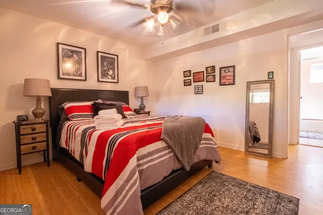 a bedroom with a bed and a chandelier