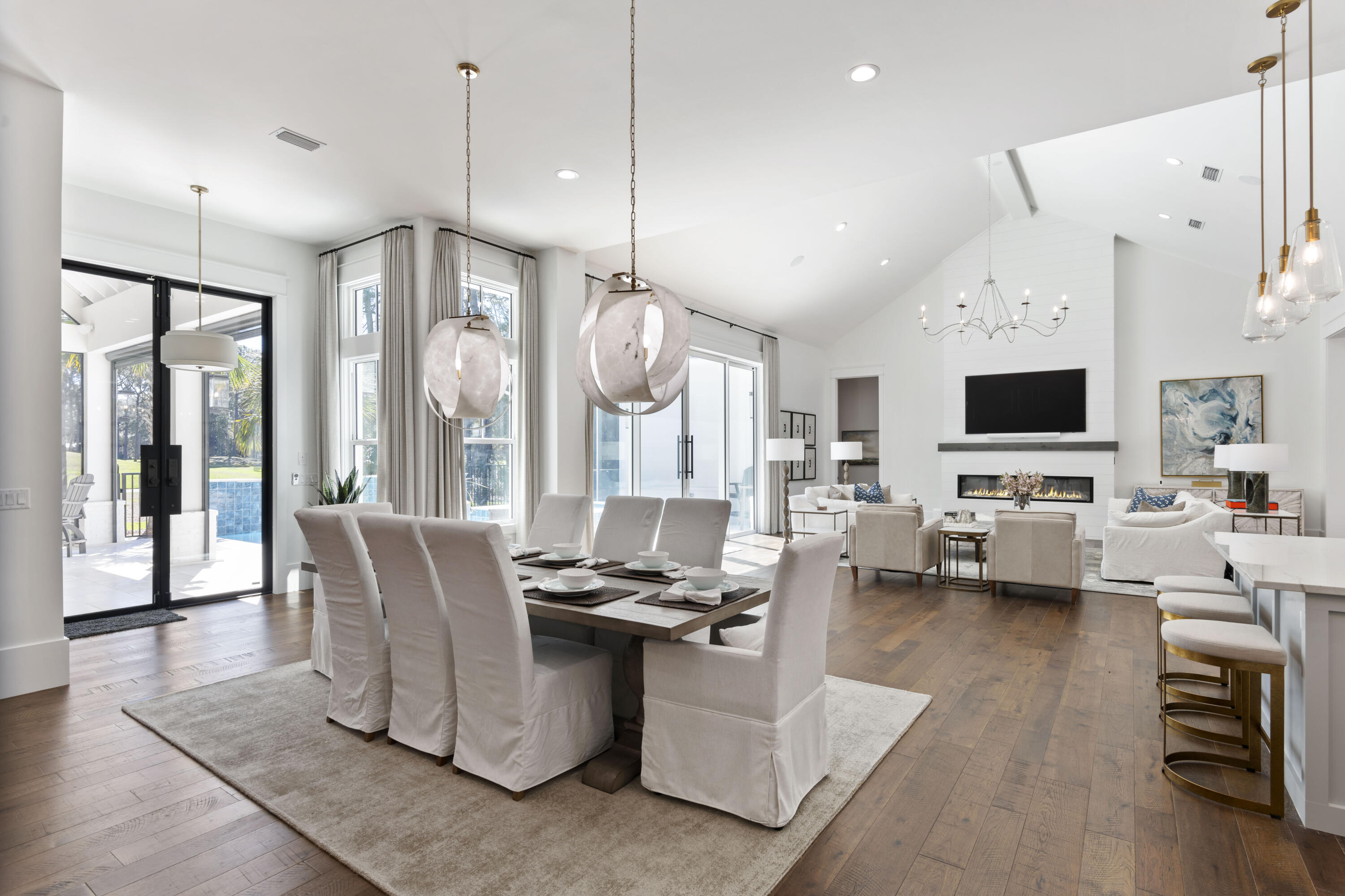 2924 Sand Pine Road Miramar Beach, FL 32550 - Photo 26 of 98 a living room with couches a flat tv screen and a chandelier with kitchen view