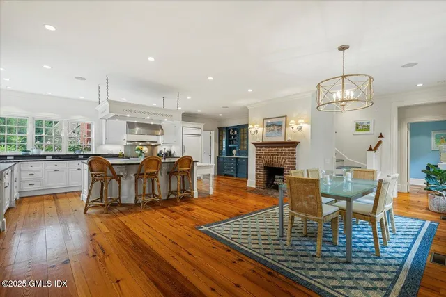 a living room with fireplace furniture and a wooden floor