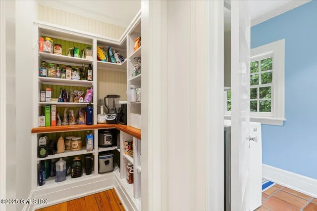 a view of a bedroom with furniture and closet