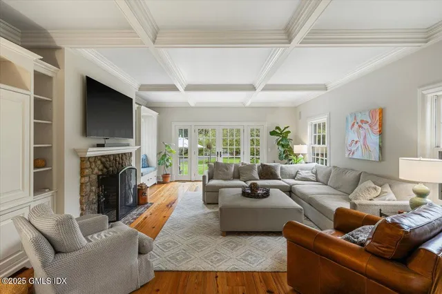 a living room with furniture fireplace and a flat screen tv