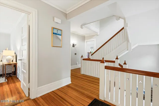 a view of entryway and hall with wooden floor