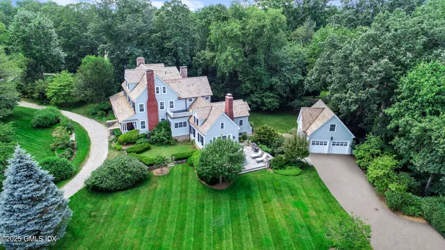 an aerial view of a house with pool and garden