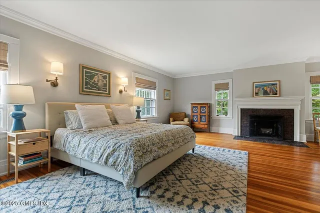 a spacious bedroom with a bed and a fireplace