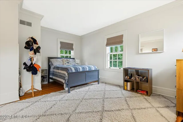 a bedroom with furniture and a window