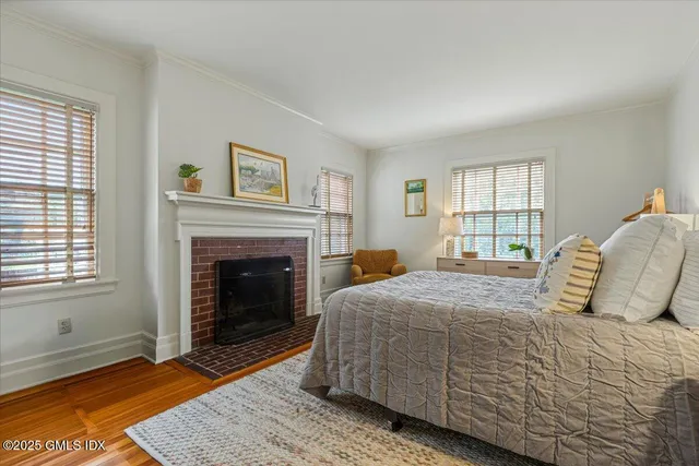 a bedroom with a bed and a fireplace
