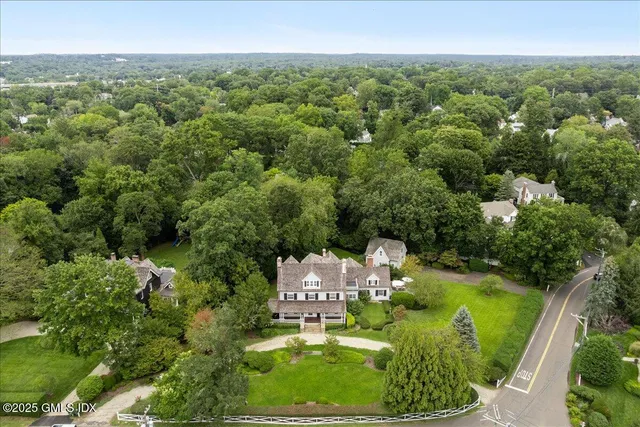 an aerial view of a residential houses with outdoor space and garden