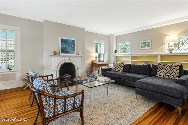 a living room with furniture a fireplace and a window