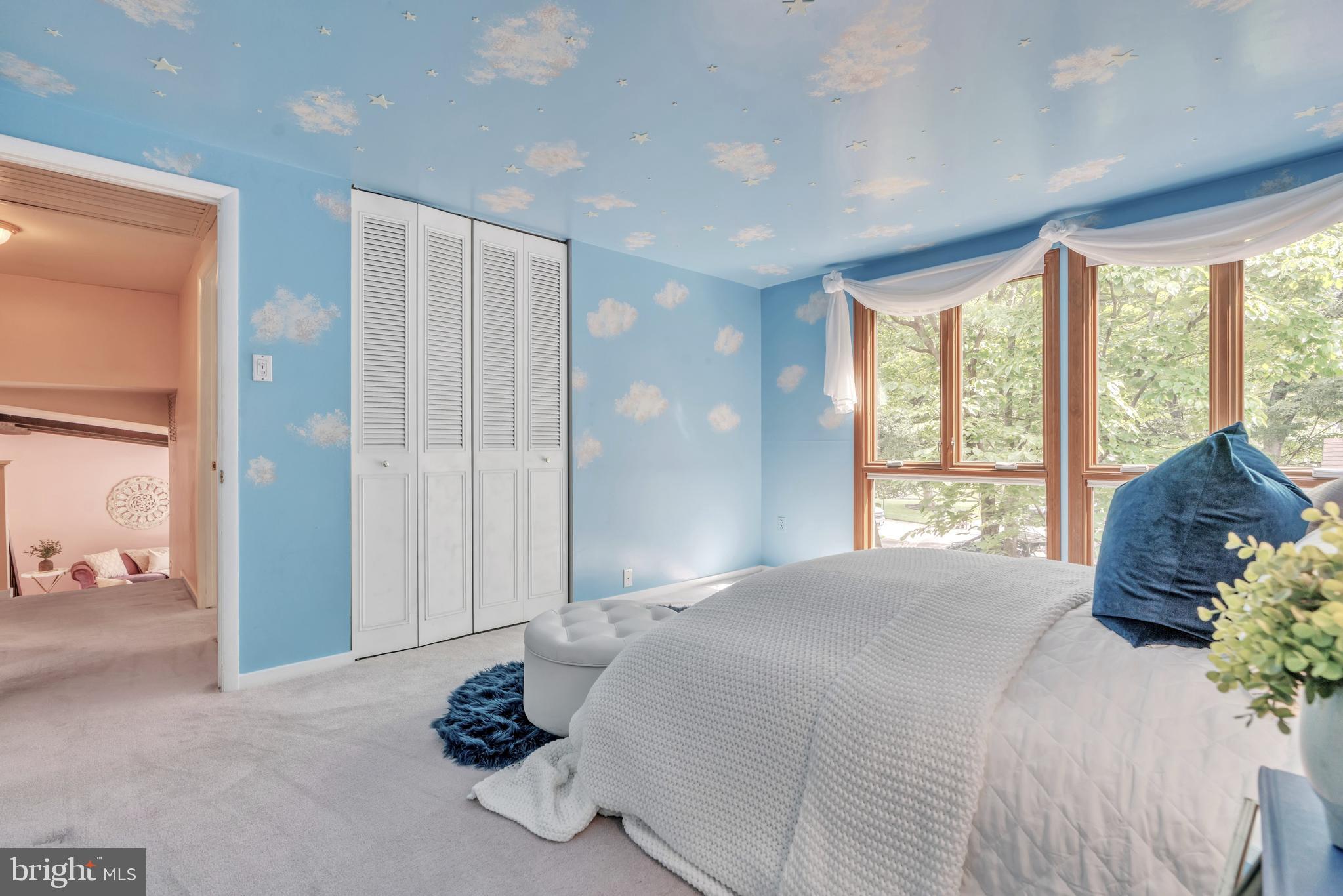 6411 Sunset Light Columbia, MD 21045 - Photo 15 of 37 a spacious bedroom with a large bed and a chandelier
