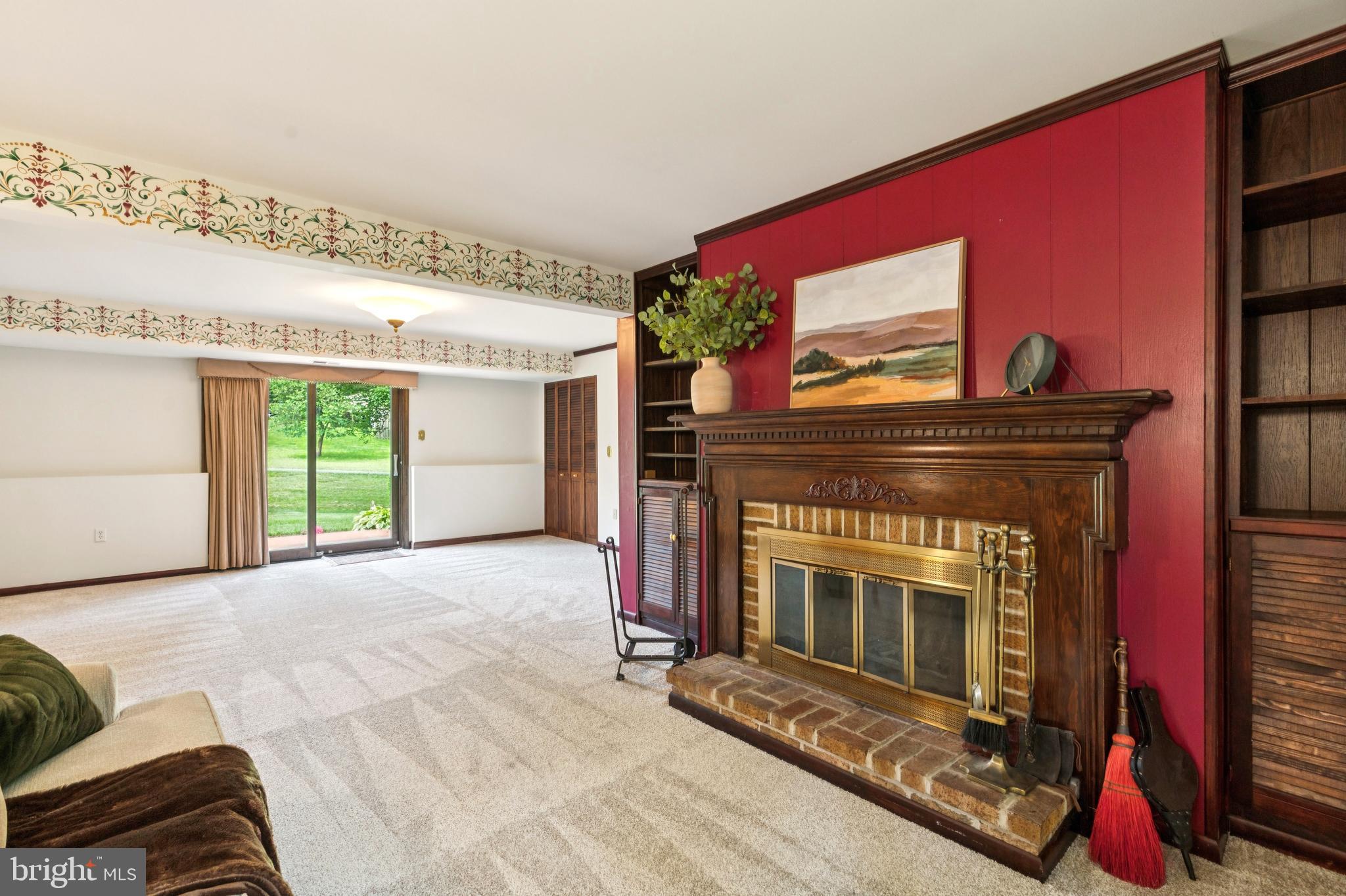 6411 Sunset Light Columbia, MD 21045 - Photo 24 of 37 a living room with furniture a fireplace and a flat screen tv