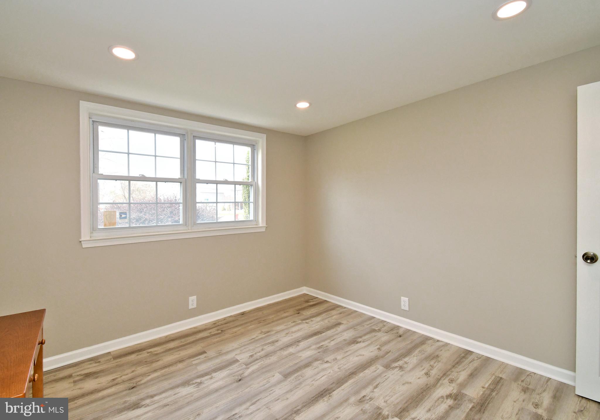 545 Brook Lane Warminster, PA 18974 - Photo 12 of 25 an empty room with wooden floor and windows