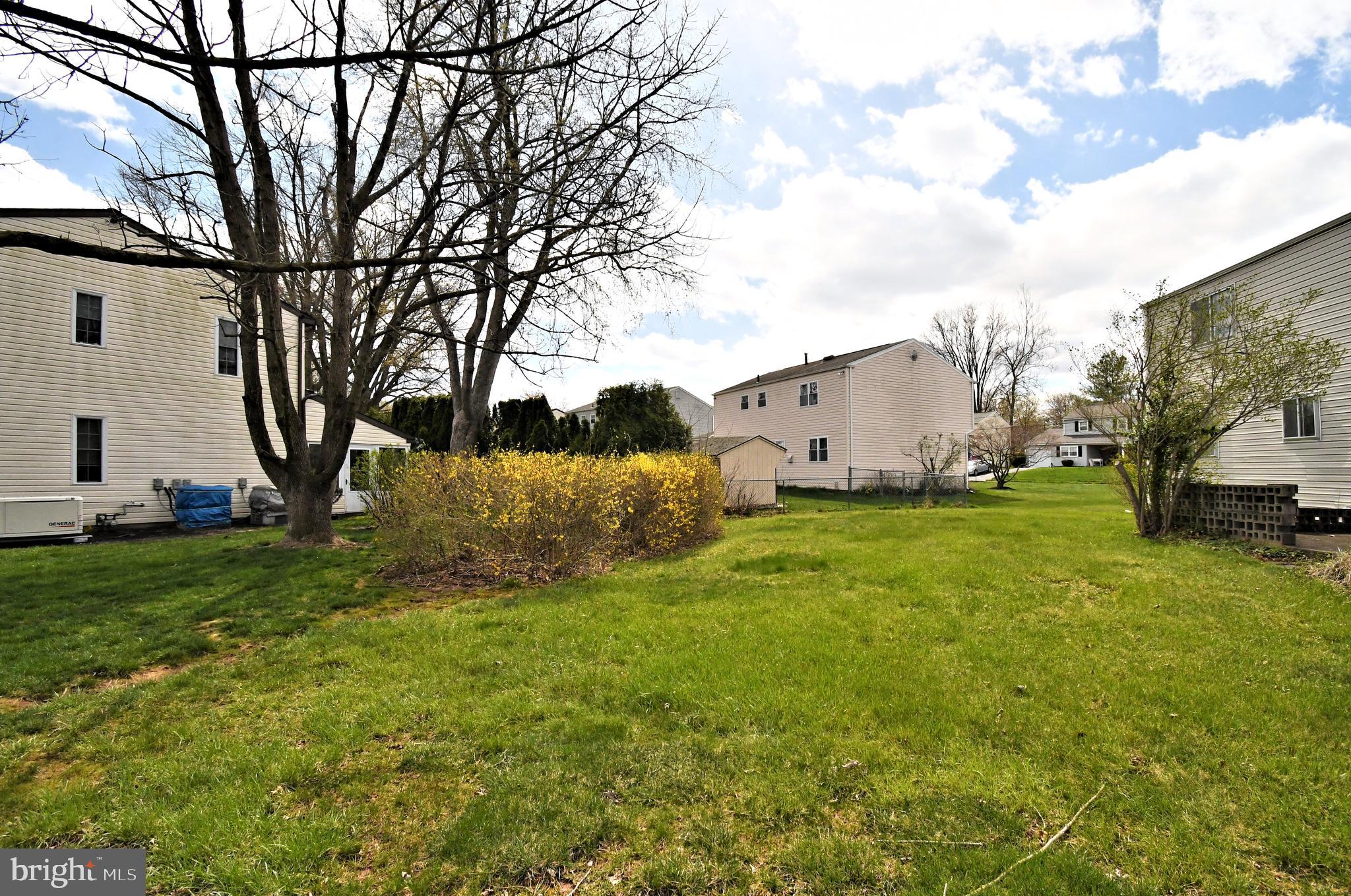 545 Brook Lane Warminster, PA 18974 - Photo 24 of 25 a view of a white house with a big yard and large trees